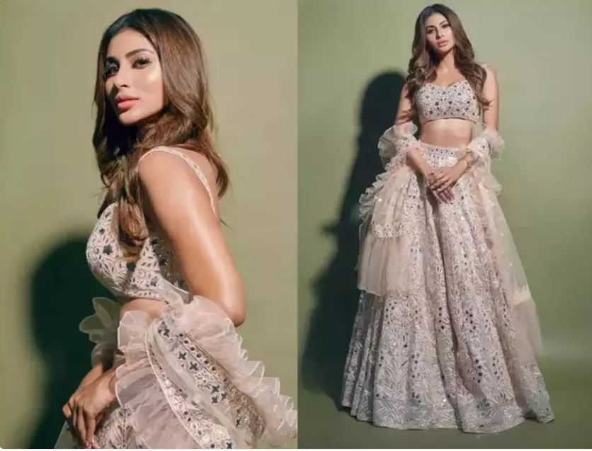 Mouni looked drop-dead gorgeous in this blingy lehenga. She was seen wearing a powder pink ensemble featuring mirror work accents, which she styled with a ruffled dupatta.